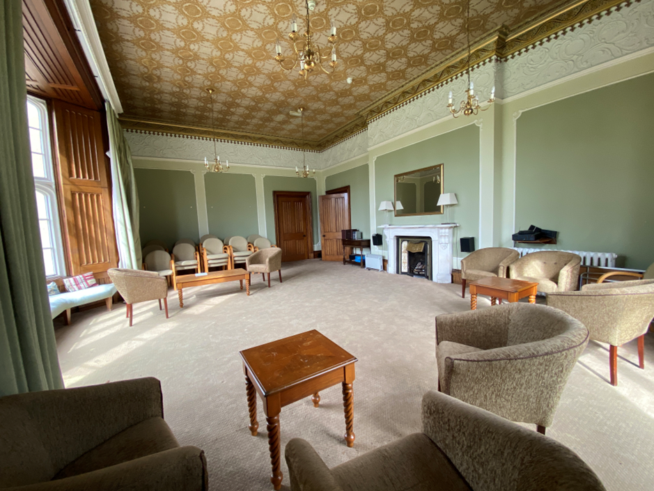 Sitting Room with historic windows, seating and garden views