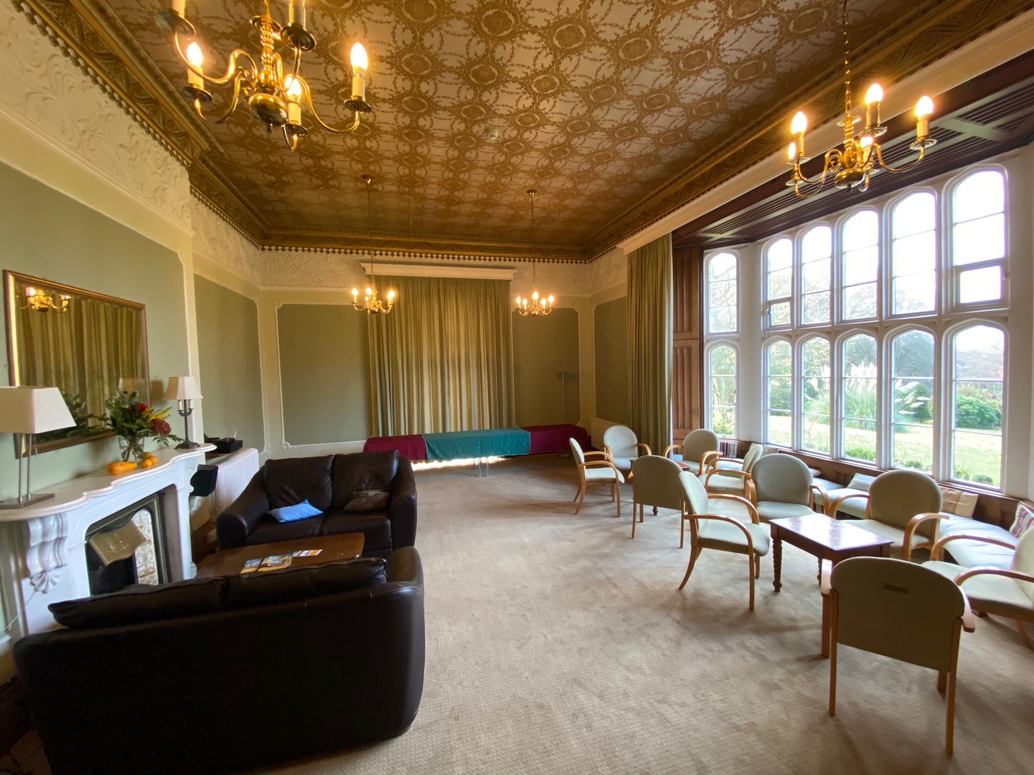 Large historic room with flexible seating and garden-facing windows